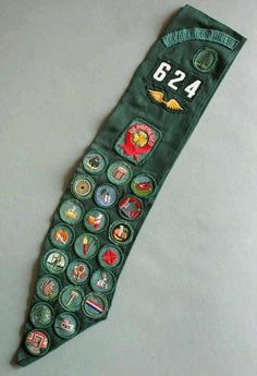 an old green army rank badge with numbers and badges on the front, sitting on a white surface