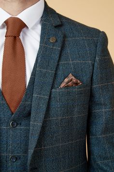 Show up in style with the blue Scott three piece suit. This vintage inspired suit draws inspiration from old age country tweeds, featuring a subtle check laid upon a durable heavyweight fabric, making it ideal for imitating that suave Peaky Blinders style. Character is added with the navy velvet contrast pocket trims and an eye-catching orange paisley pocket square peeking through the top pocket. Model wears size 40R blazer, 40R waistcoat & 34R trousers. Features Slim fit Single-breasted Notch l Non Traditional Suits For Men, Double Breasted Tweed Suit, Wedding Suits Groom Navy Blue, Irish Wedding Suit, Blue Suit With Burnt Orange Tie, Vintage Tweed Suit, All Blue Suit, Autumn Suit Men Wedding, Mens Wedding Suits Summer