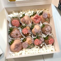 a box filled with chocolate covered strawberries and flowers