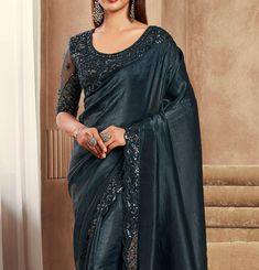 COLOR : Shimmer Peacock Black FABRIC : Saree - Fancy Silk, Blouse - Fancy Silk & Net WORK : Resham Embroidery, Stones, Sequins, Lace BorderOCCASION : Wedding, Engagement, Party Wear, Festival, Sangeet NOTE : The outfit includes blouse and saree only. Petticoat is not included. READY-TO-WEAR : No STITCHING : Available as semi-stitched fabric, can be stitched using standard size option (+$30). Note: There might be a slight color variation due to lighting and flash used during photoshoot. The brigh Formal Festive Pre-draped Saree With Intricate Embroidery, Party Wear Saree With Resham Embroidery In Raw Silk, Formal Dola Silk Blouse Piece With Zari Work, Traditional Dola Silk Blouse Piece For Formal Occasion, Traditional Formal Dola Silk Blouse Piece, Formal Saree With Resham Embroidery For Navratri, Formal Art Silk Fabric With Zari Embroidery, Party Wear Art Silk Blouse Piece With Zari Work, Party Wear Saree Blouse With Intricate Embroidery