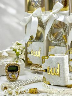 some white and gold items on a table with pearls, necklaces and other accessories