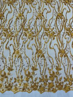 gold embroidered lace on white fabric