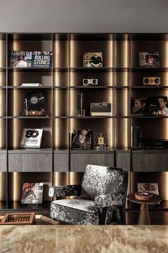 a living room filled with furniture and bookshelves next to a wall covered in shelves