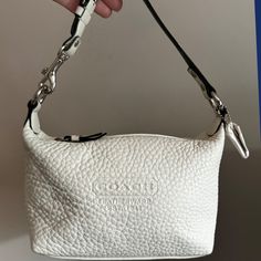 This Coach Pebble Leather Baguette Bag Is In New, Unused Condition From A Smoke-Free Home. The Bag Features A Warm White Color With Silver-Tone Hardware, And A Buttery Soft Pebble Leather Exterior. The Interior Is A Clean, Unused, Black Fabric With A Pocket, A Great Addition To Any Collection, It’s A True Coach Classic. D: 7.5" X 5" X 4". Strap Length: 11". Designer Everyday Baguette Clutch, Designer White Baguette Bag For Everyday, Daily Use Baguette Bag With Silver-tone Hardware, Everyday Baguette Satchel Bag With Silver-tone Hardware, White Soft Leather Baguette Bag, Chic Coach Baguette Bag With Removable Pouch, Chic Coach Baguette Satchel Bag, Everyday Rectangular Baguette Bag With Silver-tone Hardware, Textured Leather Rectangular Baguette Bag