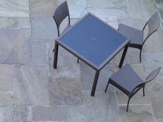 a table and chairs sitting on top of a stone floor