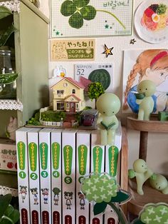 there are many books on the shelf with pictures and plants in them that are green