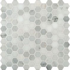 a white and gray marble mosaic tile with hexagonal design on the bottom half