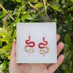 Red and Gold Snake Earrings  These snake earrings are perfect for any snake lover 🐍 made from a lightweight resin with sterling silver hooks 🌼 Red Snake-shaped Jewelry For Gifts, Snake-shaped Pierced Earrings For Gift, Snake-shaped Pierced Earrings Gift, Snake-shaped Earrings For Pierced Ears As Gift, Snake-shaped Earrings For Gifts, Snake-shaped Earrings With Ear Wire For Gift, Snake-shaped Earrings With Ear Wire As Gift, Handmade Snake-shaped Earrings As Gift, Gold Snake Earrings