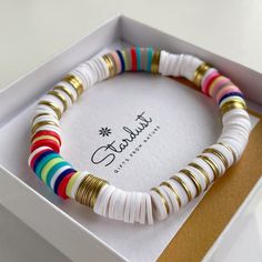 This Boho Chic bracelet has just arrived to our store. The bracelet is lightwear and feels very comfortuble. Made out of heishi beads, this bracelet is perfect for your summer tan 🤩 Base of white beads with a little touch of gold and a color splash 🌈 ⠀ ⠀ Can be mixed with other bracelets to create a boho chic style. Matches well with some organic cotton/linen dress. 👗 ⠀ All jewelry comes in premium packaging, gift ready, plus a stylish postcard All of our jewelry are designed and crafted by h White Heishi Beads Bohemian Stretch Bracelet, Bohemian White Heishi Beads Stretch Bracelet, Summer White Heishi Beads Friendship Bracelets, Handmade Bohemian White Stretch Bracelet, Heishi Bracelet Ideas Summer, Heishi Bracelet Ideas, Heishi Beads Necklace, Heishi Jewelry, Heishi Bead Bracelet