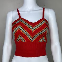 Adorable 70s red knit tank top  Brand - The Red Eye Size - Labeled Medium but it measures like a modern XS so please check all measurements to ensure fit Chest - 15.25" pit to pit, stretches to 17" Waist - 10.75" across, stretches to 15" Length - 15" (11" to underbust) Condition - Someone altered it. The straps originally connected in the back with a button/button hole but someone removed the buttons and stitched down the straps. Multicolor Fitted Retro Tank Top, Red Cotton V-neck Crop Top, Red V-neck Cotton Crop Top, Red Retro Spring Tank Top, Retro Red Spring Tank Top, Red Vest Crop Top For Summer, Red Fitted Cotton Tops, Retro Red Sleeveless Tank Top, Red Fitted Cami Tank Top