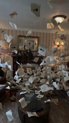 a room filled with lots of papers flying through the air