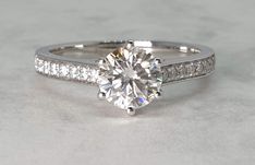 a white gold engagement ring with channel set diamonds