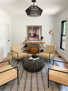 a living room filled with furniture and a painting on the wall