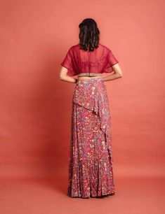 Deep Red printed chiffon layered and gathered lehenga, printed chiffon bustier, and Deep red organza pleated kimono blouse with hand embroidered lace embellishment at the hem.Dry Clean only. Ruffled Dresses For Navratri, Bohemian Georgette Dress For Reception, Bohemian Georgette Choli With Unstitched Blouse, Bohemian Blouse For Reception, Anarkali Choli With Georgette Tiered Skirt, Fitted Red Blouse With Sheer Dupatta, Red Bohemian Floral Print Sets, Navratri Ruffled Pre-draped Saree, Navratri Tiered Skirt Dress