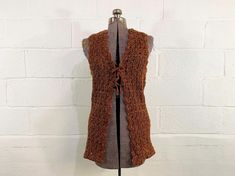 Chest: 34" Bottom Hem: 36"  Length: 31" Material: 100% acrylic Brand: Helen Sue Adorable brown and orange knit cardigan vest with a bow in the front. Super cute and in great condition. Fabric has stretch. ✂ All garments measured laying flat. Bust, waist, & hip measurements are already doubled. Please refer to the last photo for the size chart I use to determine modern sizing. ✂ All items are vintage and pre-loved. All major flaws are listed, but small blemishes like loose stitches and buttons may not be in the item description as they are to be expected when purchasing vintage items. ♡ New items are listed every week! Follow instagram.com/checkenginevintage for the latest listings and sales! ♡ All items for sale in this shop are vintage and pre-loved! This means you are receiving something Winter Orange Sleeveless Vest, Orange Sleeveless Winter Vest, Sleeveless Brown Cardigan For Fall, Fitted Orange Vest For Fall, Crochet Sleeveless Sweater Vest For Fall, Brown Knitted Sleeveless Vest, Fall Crochet Sleeveless Sweater Vest, Net Cardigan, Crochet Net