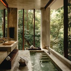 a bathroom with a large jacuzzi tub in the middle of it and lots of windows