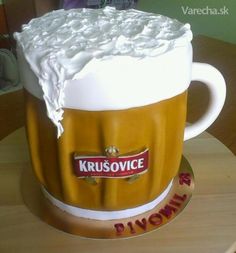 a cake made to look like a beer mug with frosting on the top and bottom