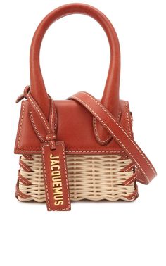 Jacquemus updates their Chiquito mini-bag with rattan and leather, with so much finesse that they seem inseparable. The proven Chiquito style takes on a summery opulence that makes us dream of sunny days.Snap flap in frontAdjustable and removable shoulder strapSignature dust bag includedMade in Italy SizeHeight: 4.5" (12 cm)Width: 3.5" (9 cm)Depth: 2.75" (7 cm) Jacquemus Logo, Jacquemus Bags, Jacquemus Le Chiquito, Jacquemus Bag, Wicker Bags, Rattan Bag, Woven Raffia, Bag Crochet, Bago