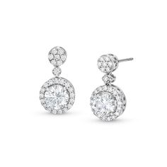 Achieve a most elegant look when you wear these round lab-created diamond frame drop earrings in white gold. Fashioned in cool 10K white gold Each drop showcases a 1 ct. round lab-created diamond sparkling in a halo of smaller lab-created diamonds. A dainty lab-created diamond connects the drop to the lab-created diamond composite post. Radiant with 2-1/2 cts. t.w. of lab-created diamonds These earrings secure comfortably with friction backs. Elegant White Halo Setting Earrings, Dazzling White Gold Earrings With Halo Setting, Dazzling Diamond White Earrings With Halo Setting, Timeless Diamond White Halo Diamond Earrings, Diamond White Halo Setting Lab-grown Diamond Earrings, Vintage Diamond Earrings, Diamond Frame, Lab Created Diamonds, Diamond Halo