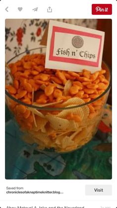 a glass bowl filled with chips on top of a table