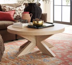 a living room with a couch, coffee table and potted plant