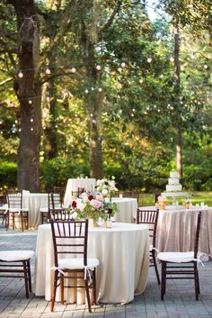 an outdoor wedding reception with tables and chairs