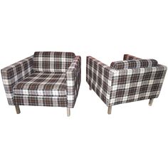 a pair of plaid chairs sitting next to each other