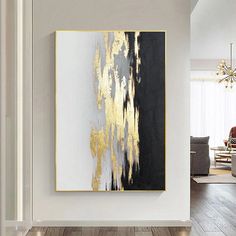 an abstract painting hangs on the wall in a living room with hardwood floors and white walls