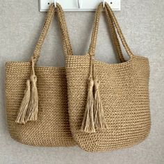 two straw bags hanging on the wall