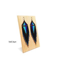 Turquoise black Geometric earrings Abstract earrings Unusual earrings Minimalist earrings Statement earrings Hippie earrings Long dangle earrings Fringe earrings Turquoise blue Seed bead earrings Czech bead earrings Beaded earrings These earrings in a fantastic, cosmic style, made of high-quality Czech beads. They have a durable titanium-colored metal hook. Colors: Black + Turquoise + Blue + Gold Length of the Earrings - 5.5 inches (14 cm) 100% handmade Czech seed beads. Shipping worldwide Gift Handmade Minimalist Beaded Dangle Earrings, Minimalist Handmade Beaded Dangle Earrings, Minimalist Earrings With Dangling Beads As Gift, Minimalist Drop Earrings With Dangling Beads, Black Long Drop Beaded Earrings For Gift, Blue Minimalist Dangle Jewelry, Artsy Blue Beaded Dangle Earrings, Black And Turquoise Beaded Earrings, Unique Blue Beaded Earrings