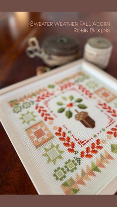 a close up of a cross stitch pattern on a table