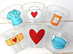 five plastic cups with medical themed stickers on them