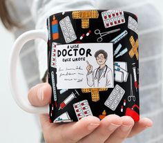 a woman holding a coffee mug with doctor on it's front and back sides