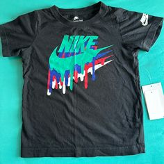 Nike Boys Short Sleeve Shirt. Nike Black T-shirt For Spring, Black Graphic Shirt For Spring, Playful Black T-shirt For Spring, Black Graphic Design Shirt For Spring, Multicolor Letter Print Shirt, Playful Black Cotton Shirt, Fun Black Tops With Graphic Design, Nike Black Summer T-shirt, Nike Multicolor Graphic Print T-shirt