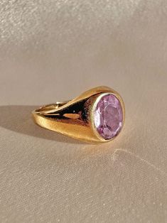 Antique 9k yellow gold ring from the United Kingdom c 1916 featuring a beautiful light lilac faceted amethyst in a bezel setting. Good antique condition, slight wear and fade to amethyst. Size: 7.5 resizable* Weight: 3.5 grams Band: 11.6 mm (front), 1.5 mm (back) Amethyst: 9.0 mm x 7.5 mm Hallmarks: crown for gold, 375 for 9k, "R" for 1916, 'FM' for makers mark Luxury Purple Classic Signet Ring, Luxury Purple Signet Ring For Engagement, Luxury Classic Purple Signet Ring, Luxury Purple Elegant Signet Ring, Luxury Purple Hallmarked Signet Ring, Luxury Antique Cabochon Signet Ring, Luxury Classic Amethyst Signet Ring, Amethyst Signet Ring, Lilac Amethyst