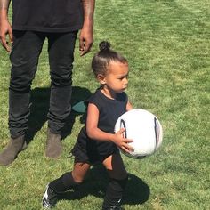 North West playing soccer while Kanye lingers in the background on the field. North West Kim Kardashian, North West Style, North West Baby, Jenner Kids, Kardashian Show, Kanye West And Kim, Saint West, Playing Soccer