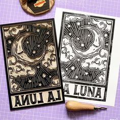 two cards with designs on them sitting next to a pair of scissors and a rubber stamp