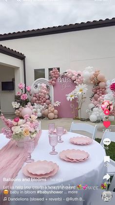 a table set up for a baby shower with balloons and flowers