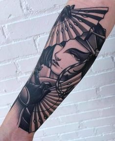 a woman's arm with an egyptian tattoo design on the left side of her body