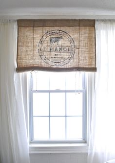 a window with a burlocked valance hanging from it's side