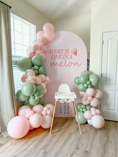 balloon arch with pink, green and white balloons in front of a sign that says avery's one in a melon