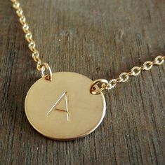 My Kiersten gold initial necklace is personalized with your choice of letter, hand stamped onto the charm creating a lovely custom necklace. This hand stamped 5/8" charm (size of US dime) is hand stamped with your choice of letter (or word, design, number) using traditional tools.  I polish and hang the piece from a gold-filled cable chain (choose 16", 18" or 20" at checkout).  Gold-filled metal contains a double layer (front/back) of gold that is much, much thicker than gold-plated metal.  Gold Adjustable Gold Initial Necklace For Personalized Gift, 14k Gold Personalized Initial Necklace, Personalized 14k Gold Initial Necklace As Gift, Gold Personalized Initial Necklace Adjustable, Gold Monogram Initial Necklace As Anniversary Gift, Gold Monogram Initial Necklace For Anniversary Gift, Gold Hand Stamped Name Necklace For Mother's Day, Personalized Yellow Gold Initial Necklace For Anniversary, Gold Initial Necklace With Custom Name For Anniversary