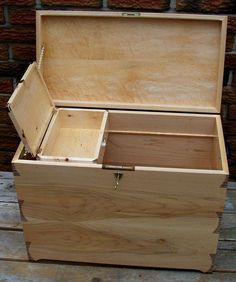 an open wooden box sitting on top of a wooden table