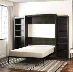 a bedroom with a bed, bookshelf and window