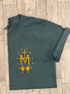 Catholic T Shirt, Cotton T-shirt With Screen Print For Gift, Cotton T-shirt With Screen Print As Gift, Green Crew Neck T-shirt With Custom Embroidery, Cotton Crew Neck Shirt With Embroidered Graphics, Cotton Shirt As A Gift, Green Cotton T-shirt With Embroidered Graphics, Embroidered Crew Neck Tops For Gifts, Crew Neck Shirt With Screen Print As Gift