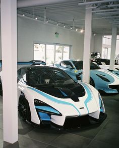 several different colored sports cars in a showroom