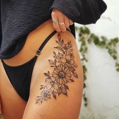 a woman's thigh with flowers on it