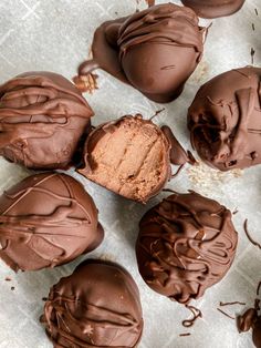 chocolate truffles with frosting and sprinkles arranged on parchment paper