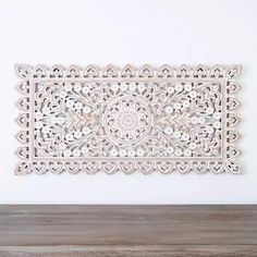 a white wall hanging on top of a wooden table