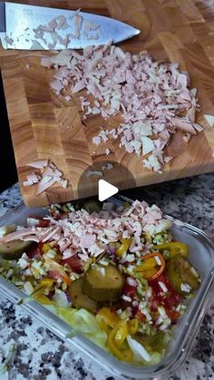 a cutting board with chopped vegetables on it and a knife in the middle next to it